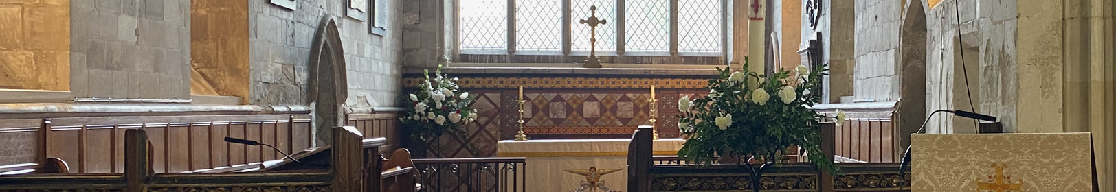 The interior of Trumpington church alter, pews and flower arrangements